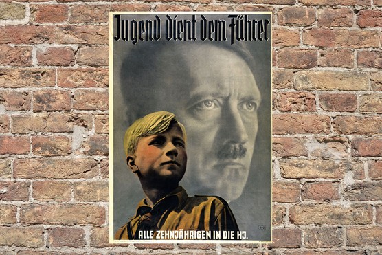 A poster showing a black and white photo of Hitler with a young blond boy in the foreground