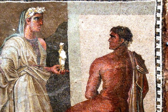 ancient-roman-bathing-latrine-culture This Roman mosaic depicts Orestes and Iphigenia, with Iphigenia holding a small statue of Artemis — imagery drawn from Greek myth and popular across the Roman world. Mosaics like this often decorated the floors of bath complexes and latrines, where vibrant storytelling scenes enlivened communal spaces.