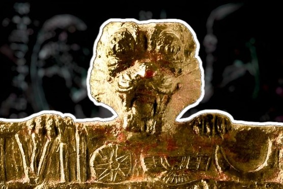 A representation of the ancient Mesopotamian demon Pazuzu, in front of a carving. (Photo by Getty/Alamy)