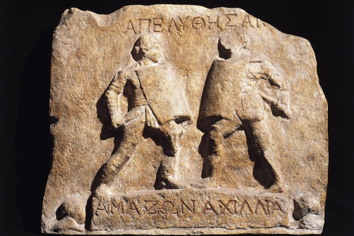 Roman civilization, Relief portraying fight between female gladiators This marble relief from Halicarnassus, dating to the 1st–2nd centuries AD, commemorates the honourable discharge of two female gladiators known as “Amazon” and “Achillia.” Shown armed like their male counterparts but bareheaded to reveal their hairstyles, the pair exemplifies the rare but striking presence of women in the arena — a reminder of the diversity and spectacle that characterised Roman gladiatorial combat.