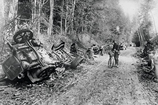 A French soldier pictured next to wrecked German lorries.