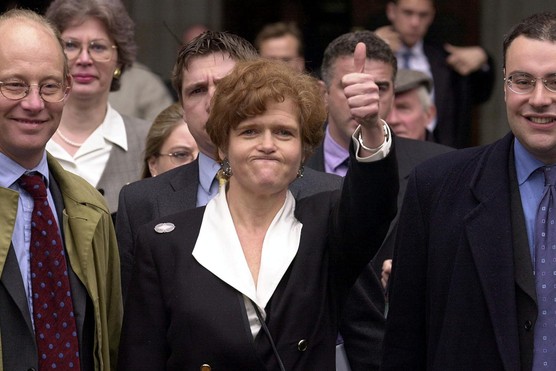 US academic Deborah Lipstadt exults the High Court in London after winning a libel case brought against her by British historian David Irving, 11 April 2000. (Photo by Martyn Hayhow/AFP/Getty Images)