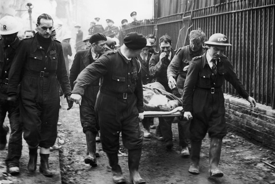 A woman is carried away on a stretcher following a German bombing raid on London, c1940. (Photo by Fox Photos/Hulton Archive/Getty Images)