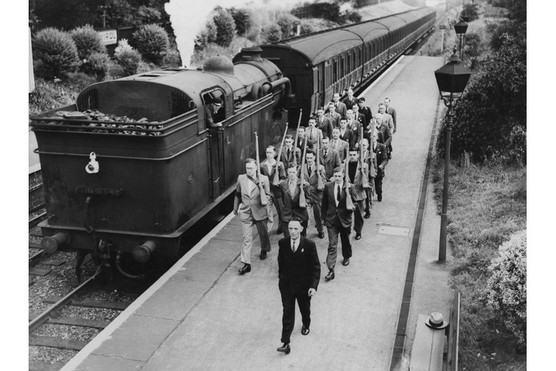 Members of the Palmers Green and Winchmore Hill LNER (London and North Eastern Railway) LDV (Local Defence Volunteers) dressed in their civilian clothes march along a platform passing a steam locomotive on 1 July 1940 in London. (Photo by Harry Todd/Fox Photos/Hulton Archive/Getty Images)
