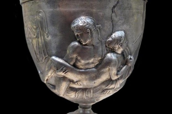 A cup depicting a male couple making love