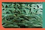 A detail of the decorative carving on the side of the Oseberg cart c850 AD. A woman with streaming hair apparently restrains a man’s sword arm as he strikes at a horseman accompanied by a dog. Below is a frieze of intertwined serpentine beasts. (Photo by Werner Forman/Universal Images Group/Getty Images)