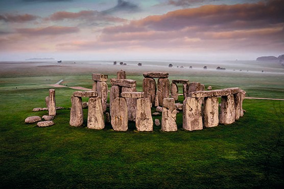 A photo of Stonehenge with plains in the background
