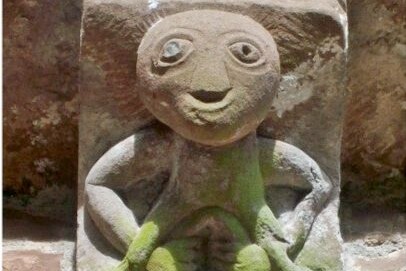 An architectural grotesque of a woman displaying her vulva