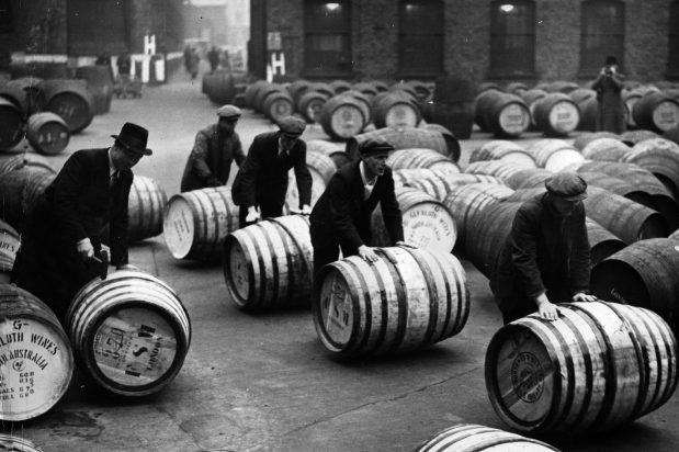 Dockers unloading wine barrels
