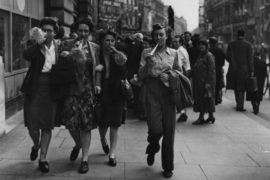 VE Day revellers blowing party trumpets