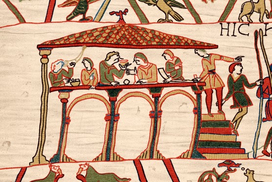 A scene from the Bayeux Tapestry shows a group of men sitting at a high
